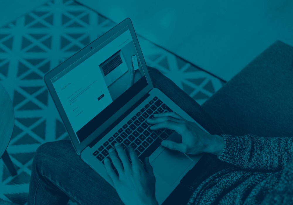Person managing travel insurance policy on Hepburns Millstream online portal, designed for Jersey, Guernsey, and Alderney residents